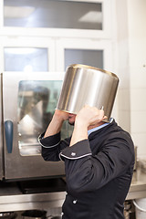 Image showing Chef cooking a vegetables stir fry over a hob