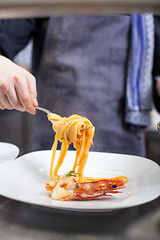 Image showing Chef plating up seafood pasta