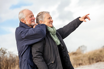 Image showing happy elderly senior couple walking on beach