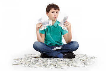 Image showing boy sitting on money