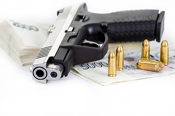 Image showing gun with bullet and czech banknotes