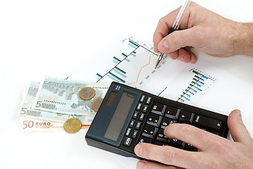 Image showing men analyzing business graph with glasses in the background