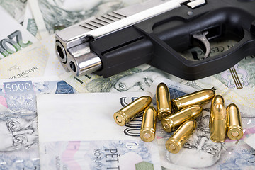 Image showing gun with bullet on czech banknotes