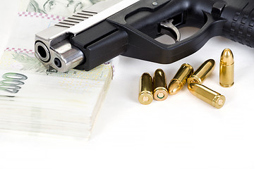 Image showing gun with bullet and czech banknotes