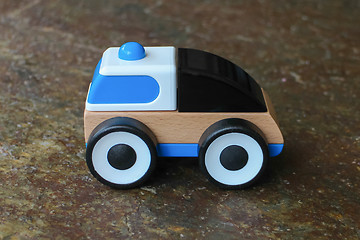 Image showing Simple wood and plastic toy police car