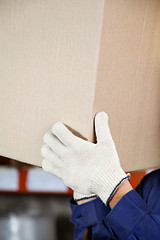 Image showing Foreman's Hands Lifting Cardboard Box