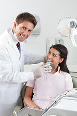 Image showing Male Dentist Showing Result Of His Work To Patient