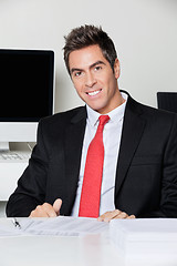 Image showing Happy Businessman Sitting At Desk