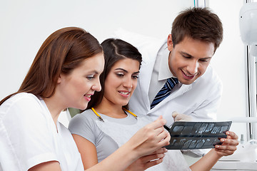 Image showing Female Nurse And Dentist Explaining X-Ray Report To Patient