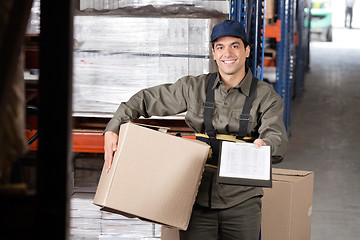 Image showing Male Supervisor With Clipboard And Cardboard Box