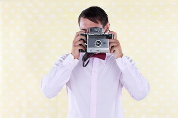 Image showing Man Looking Through Old Medium Format Camera