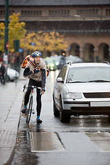 Image showing Male Cyclist With Backpack Using Walkie-Talkie On Street