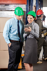 Image showing Supervisors Using Digital Tablet At Warehouse
