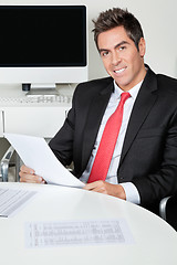 Image showing Happy Businessman Holding Document