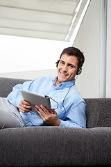 Image showing Man Listening Music On Digital Tablet