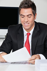 Image showing Businessman Reading Document In Office