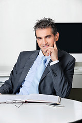 Image showing Confident Businessman Sitting At Desk