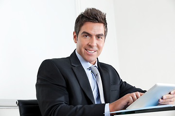 Image showing Young Businessman Using Digital Tablet In Office