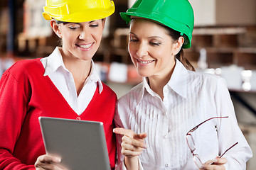 Image showing Female Supervisors Using Digital Tablet At Warehouse