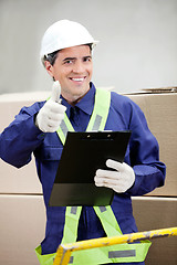 Image showing Supervisor With Clipboard Gesturing Thumbs Up