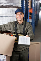 Image showing Male Supervisor With Clipboard And Cardboard Box