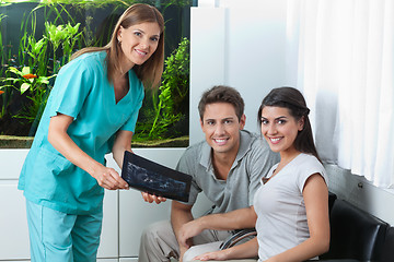 Image showing Dentist Showing Dental X-Ray To Couple