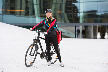 Image showing Female Cyclist With Courier Delivery Bag