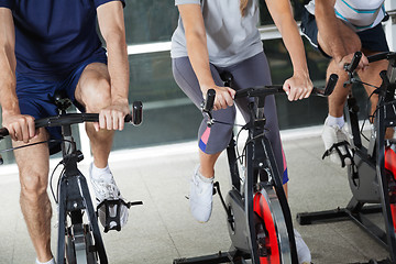 Image showing Low Section Of People On Exercise Bikes