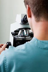 Image showing Male Researcher Using Microscope In Laboratory