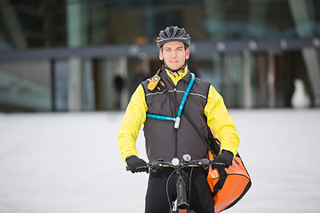 Image showing Male Cyclist Carrying Courier Delivery Bag