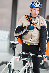 Image showing Male Cyclist With Courier Bag Using Walkie-Talkie