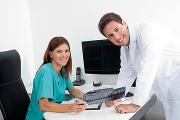 Image showing Happy Dentist And Assistant With X-Ray Report