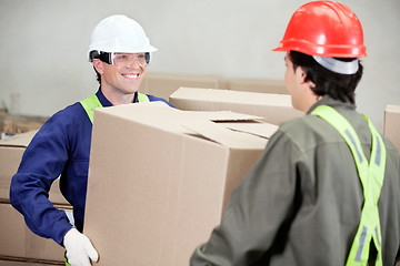 Image showing Foremen Carrying Cardboard Box At Warehouse