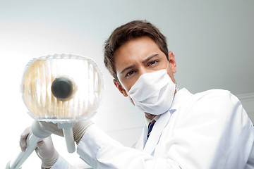 Image showing Dentist Holding Dental Lamp