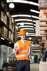 Image showing Male Supervisor Using Cell Phone At Warehouse