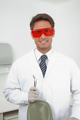 Image showing Happy Dentist Holding Tools