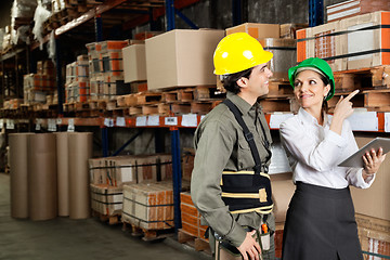 Image showing Supervisor With Foreman Pointing At Stock On Shelves