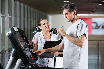 Image showing Instructor Looking At Male Client On Treadmill