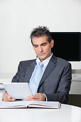 Image showing Businessman Using Digital Tablet At Desk