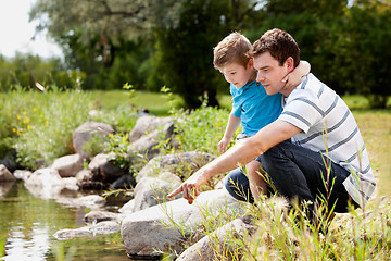 Image showing Fashing and Son Playing Near Lake