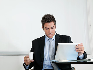 Image showing Businessman With Coffee Cup Using Digital Tablet