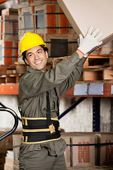 Image showing Foreman Lifting Cardboard Box At Warehouse