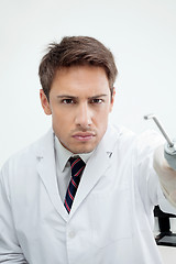 Image showing Dentist Holding Water Spraying Tool