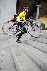 Image showing Courier Delivery Man With Bicycle And Backpack Walking Up Steps