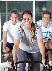 Image showing Men And Woman On Exercise Bikes
