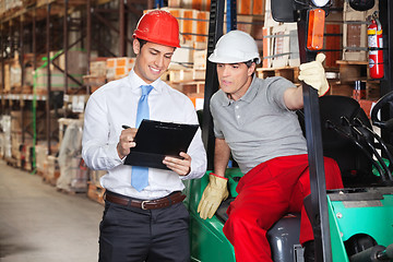 Image showing Supervisor Showing Clipboard To Foreman