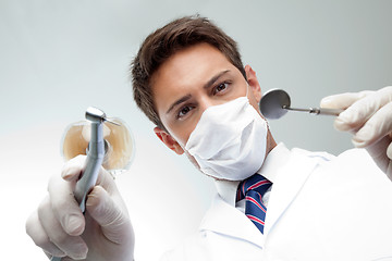 Image showing Dentist Holding Angled Mirror And Drill