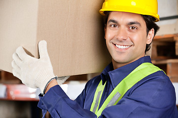 Image showing Young Foreman Lifting Cardboard Box