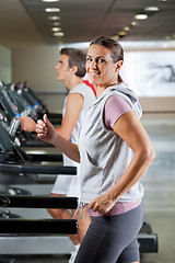 Image showing Woman And Man Running On Treadmill