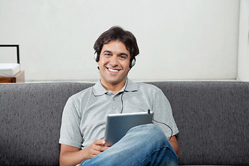 Image showing Man Listening Music On Tablet PC